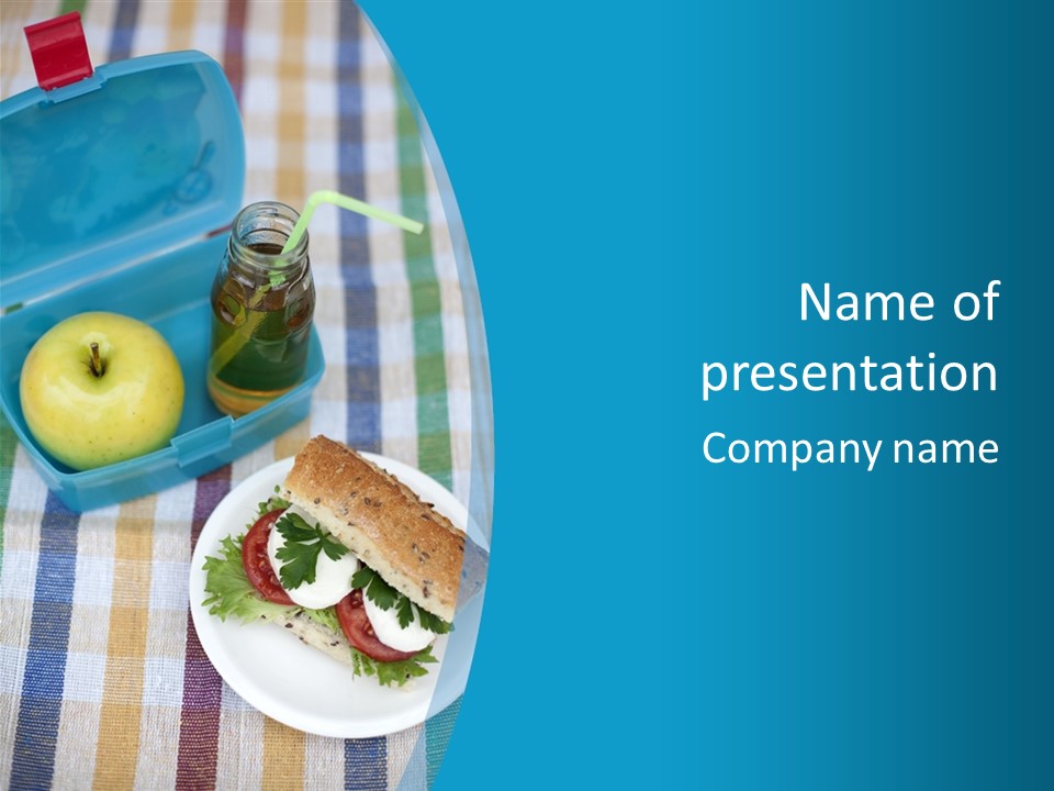 A Lunch Box With A Sandwich And An Apple On A Table PowerPoint Template