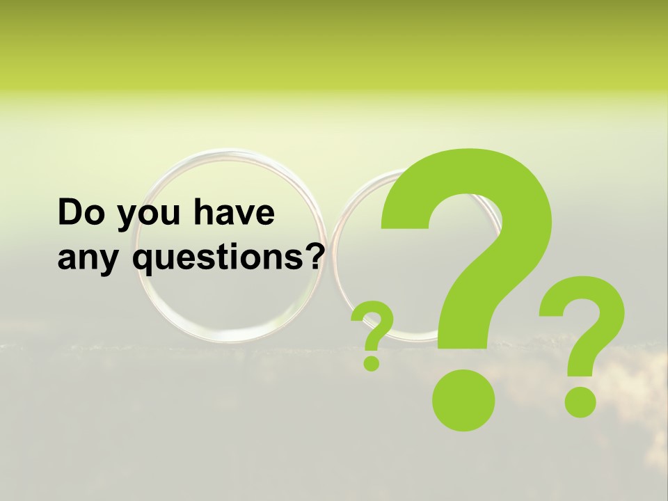 Two Wedding Rings Sitting On A Piece Of Wood PowerPoint Template