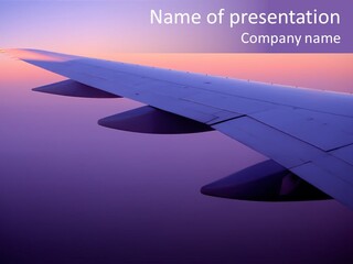 A View Of The Wing Of An Airplane In The Sky PowerPoint Template
