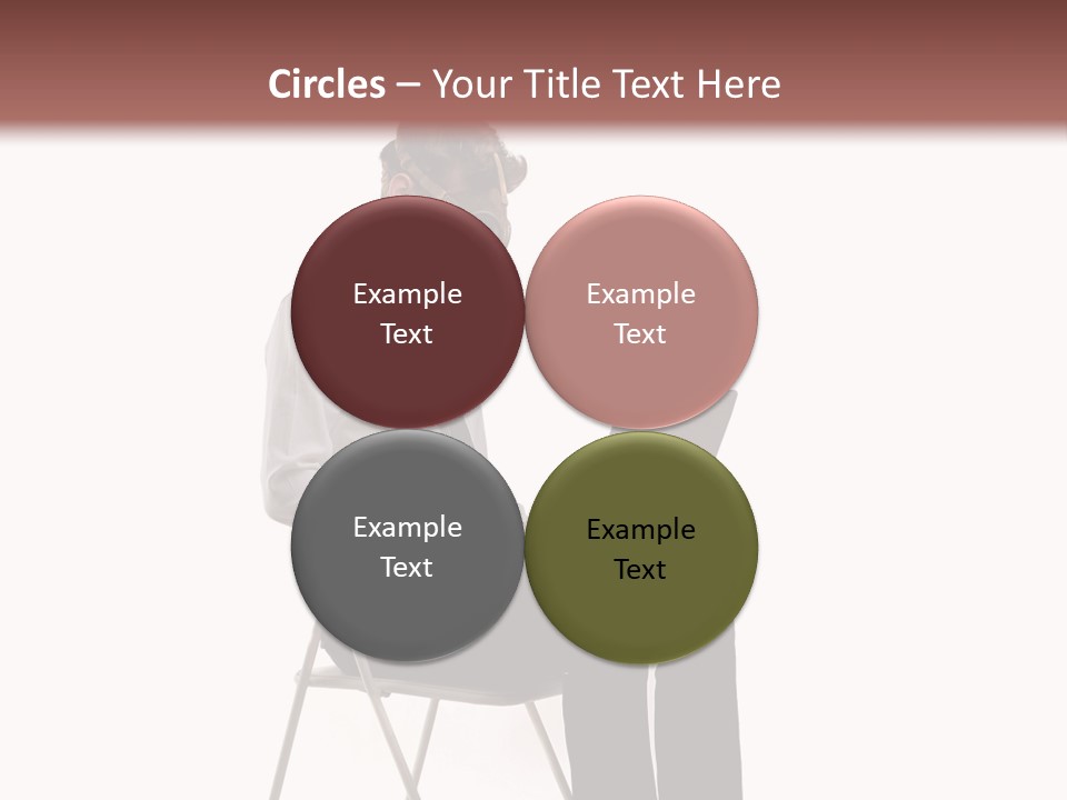 A Man Sitting On A Chair Using A Laptop Computer PowerPoint Template