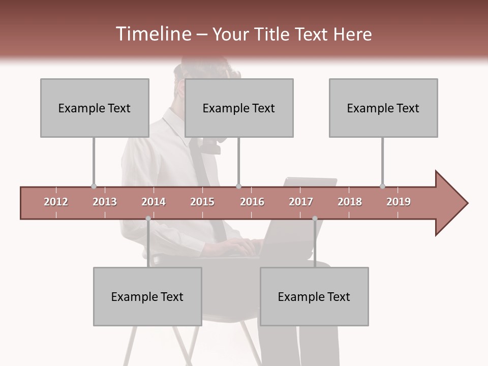 A Man Sitting On A Chair Using A Laptop Computer PowerPoint Template