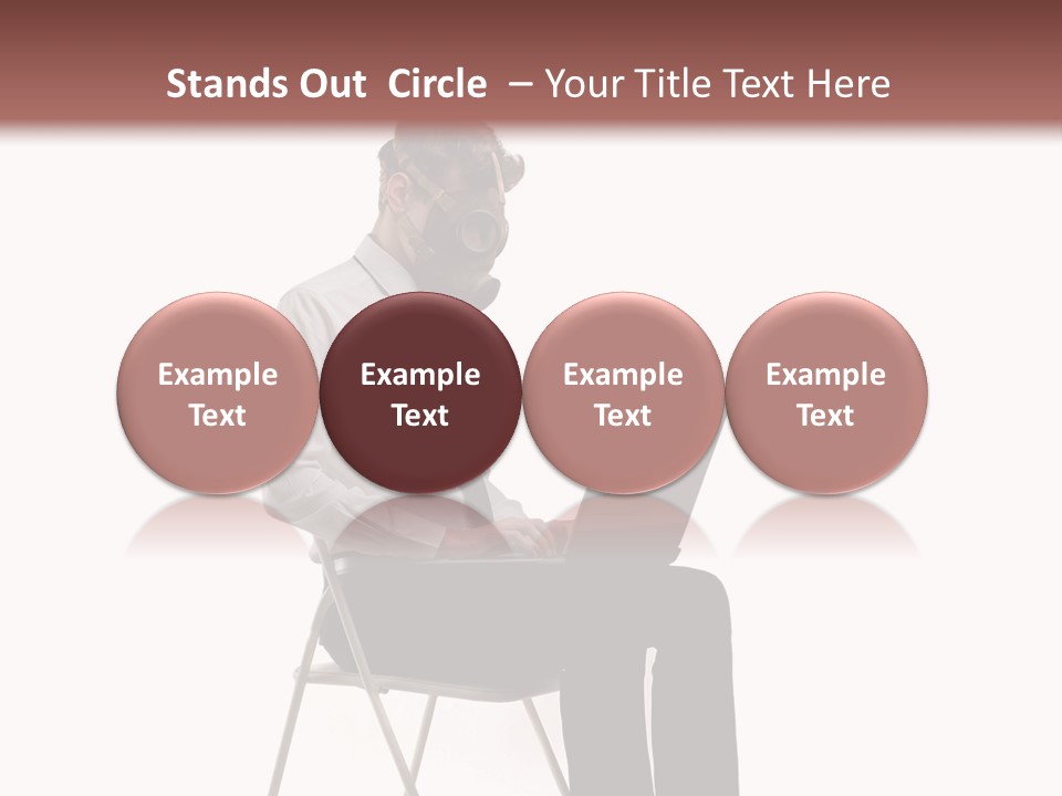 A Man Sitting On A Chair Using A Laptop Computer PowerPoint Template