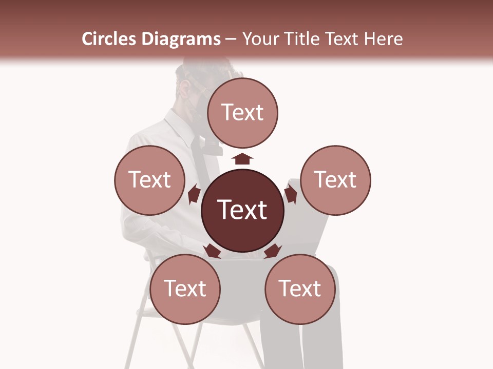 A Man Sitting On A Chair Using A Laptop Computer PowerPoint Template