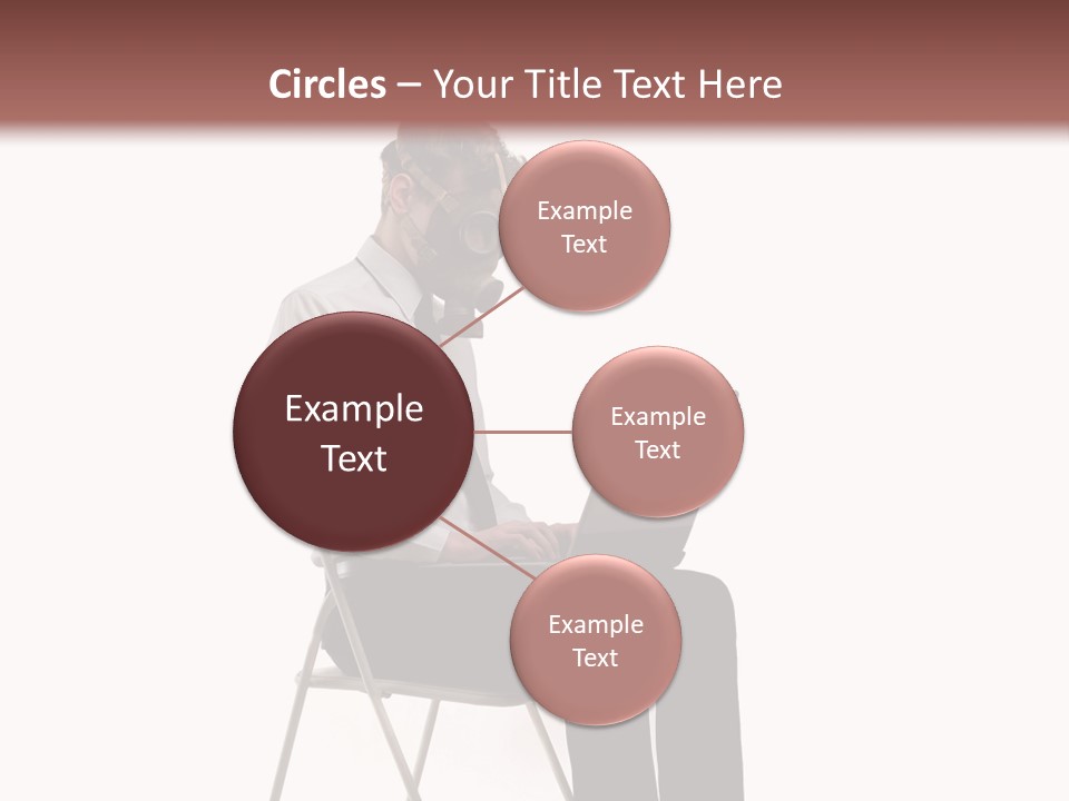 A Man Sitting On A Chair Using A Laptop Computer PowerPoint Template