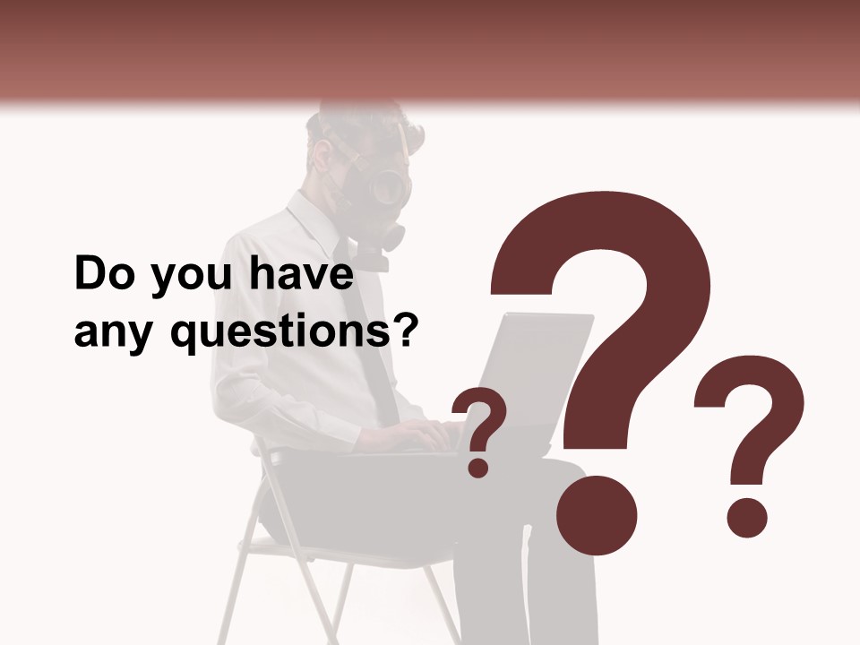 A Man Sitting On A Chair Using A Laptop Computer PowerPoint Template