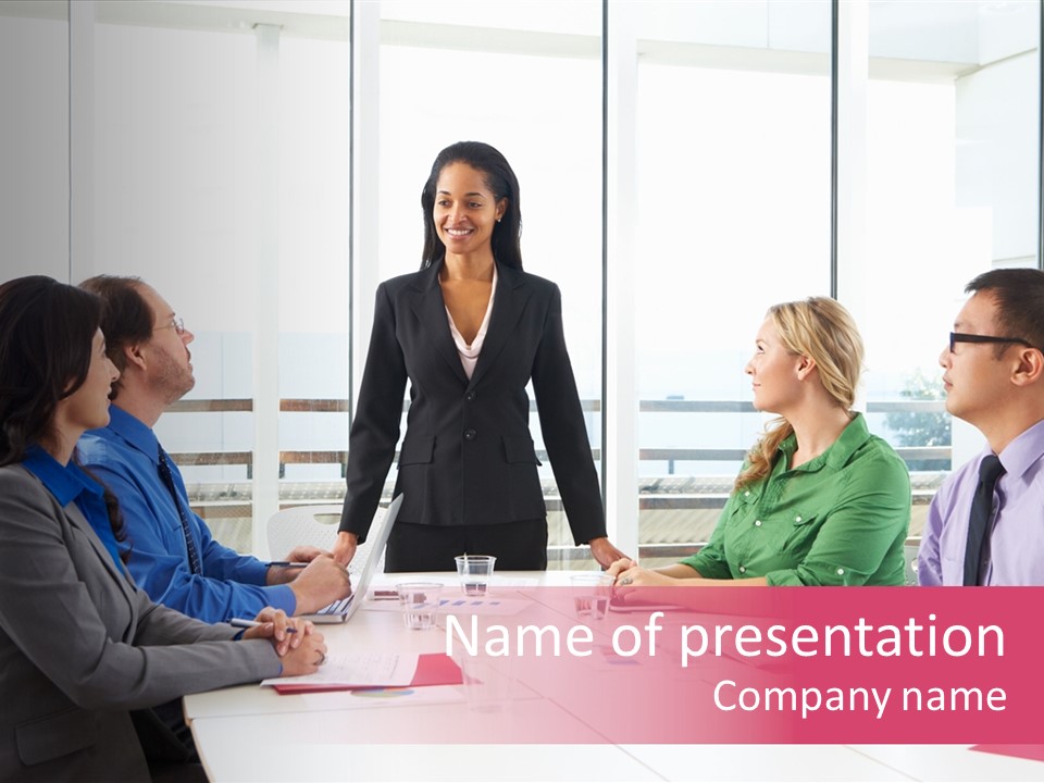 A Woman Standing In Front Of A Group Of Business People PowerPoint Template