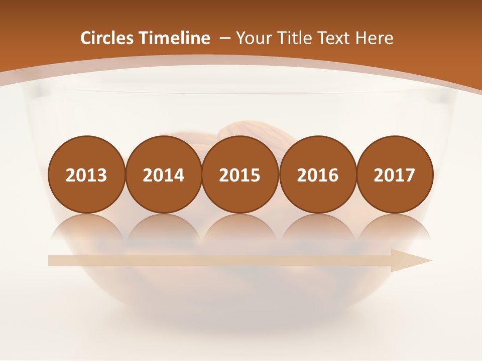 A Glass Bowl Filled With Almonds On Top Of A Table PowerPoint Template