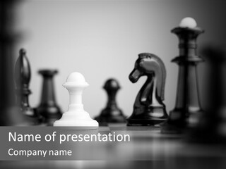 A Black And White Photo Of Chess Pieces PowerPoint Template