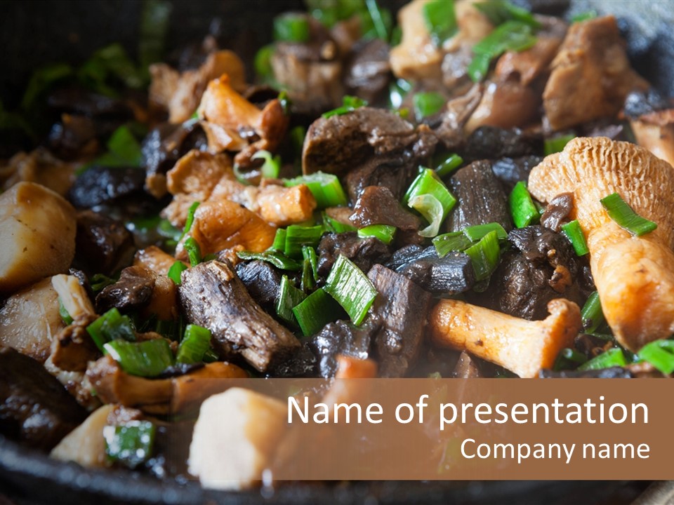 A Skillet Filled With Meat And Vegetables On Top Of A Table PowerPoint Template