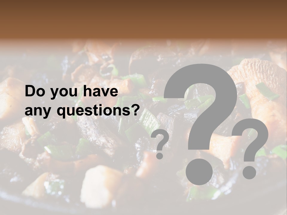 A Skillet Filled With Meat And Vegetables On Top Of A Table PowerPoint Template