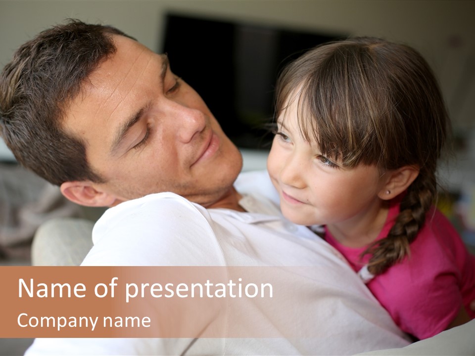 A Man Holding A Little Girl In His Arms PowerPoint Template