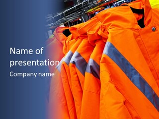 A Group Of Orange Jackets Hanging On A Rack PowerPoint Template
