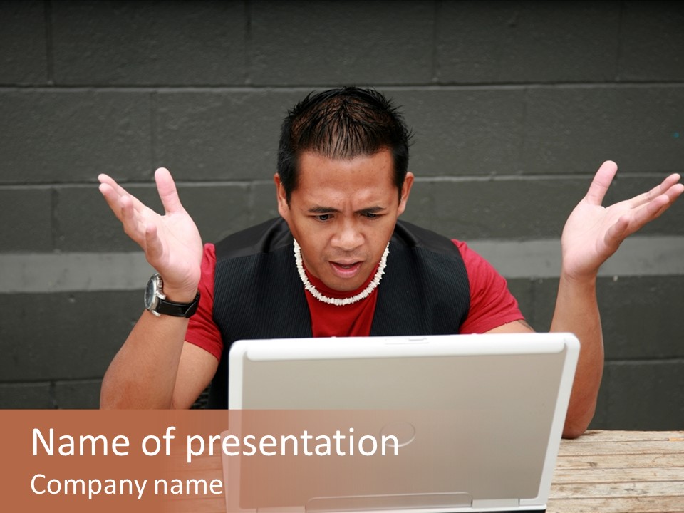 A Man Sitting In Front Of A Laptop Computer PowerPoint Template