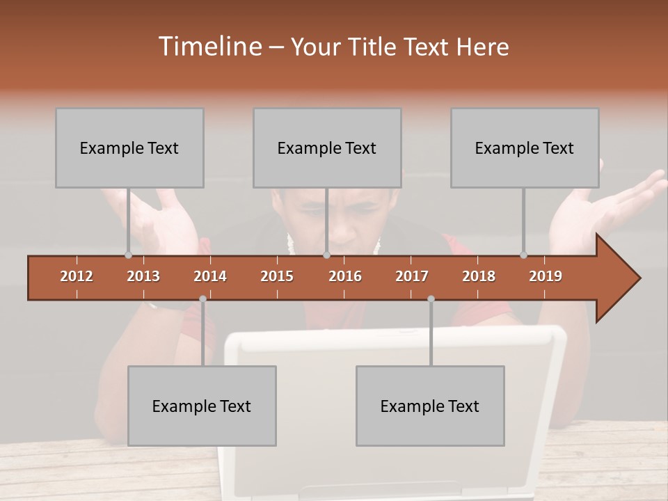A Man Sitting In Front Of A Laptop Computer PowerPoint Template