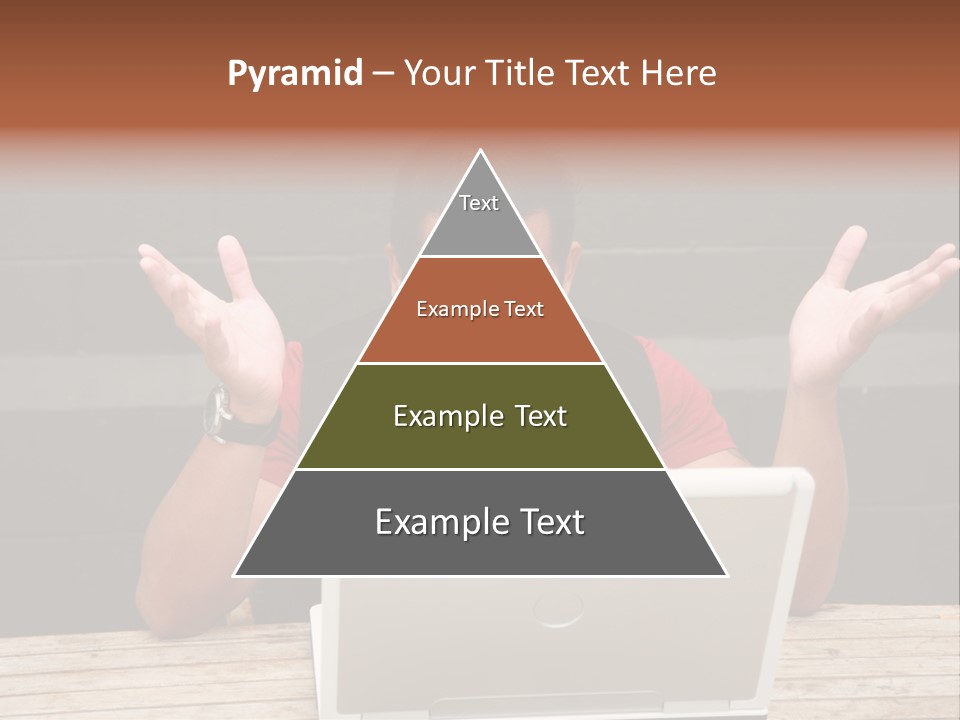 A Man Sitting In Front Of A Laptop Computer PowerPoint Template