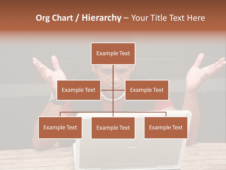 A Man Sitting In Front Of A Laptop Computer PowerPoint Template