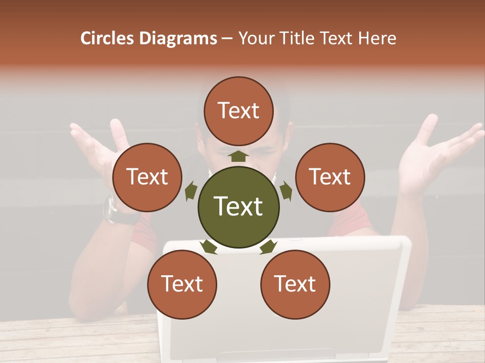 A Man Sitting In Front Of A Laptop Computer PowerPoint Template