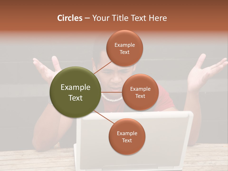 A Man Sitting In Front Of A Laptop Computer PowerPoint Template