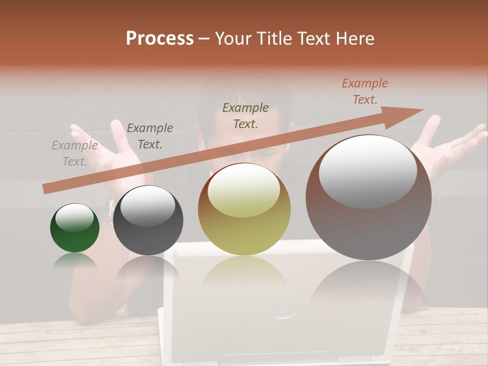 A Man Sitting In Front Of A Laptop Computer PowerPoint Template