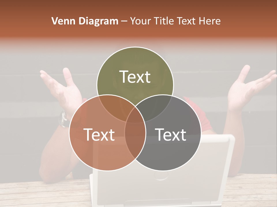 A Man Sitting In Front Of A Laptop Computer PowerPoint Template