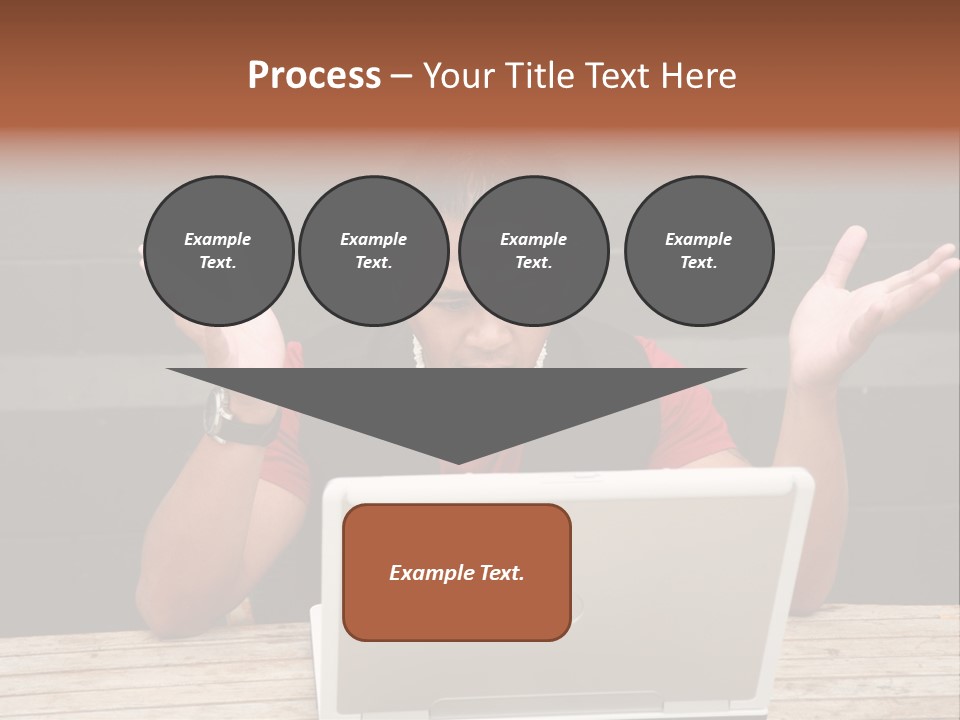 A Man Sitting In Front Of A Laptop Computer PowerPoint Template