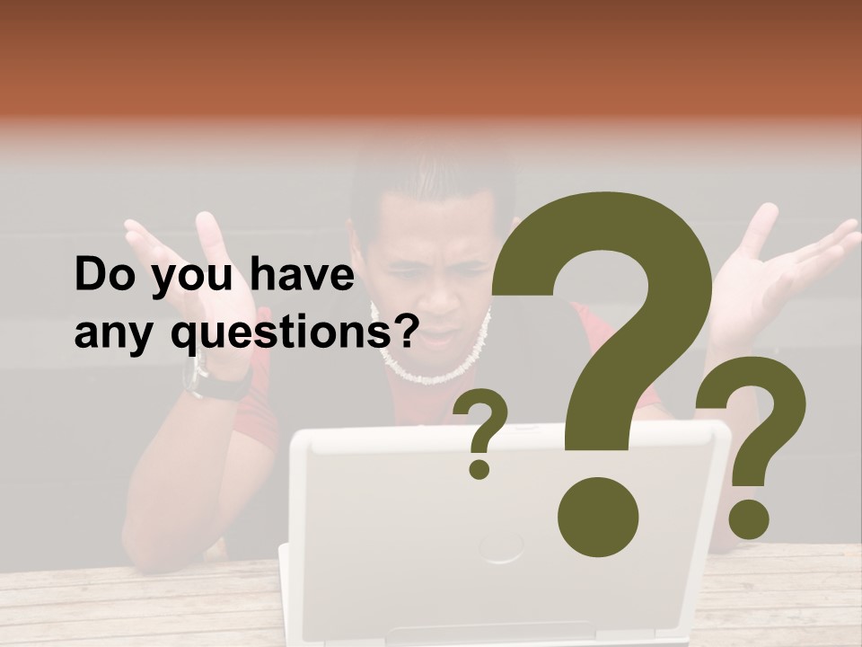 A Man Sitting In Front Of A Laptop Computer PowerPoint Template