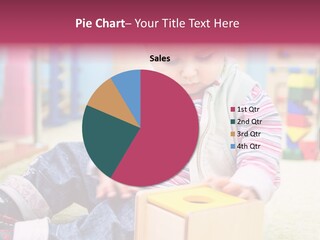 A Young Child Playing With A Toy Box PowerPoint Template