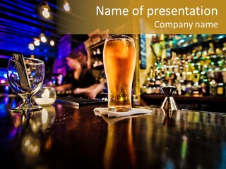 A Glass Of Beer Sitting On Top Of A Table PowerPoint Template