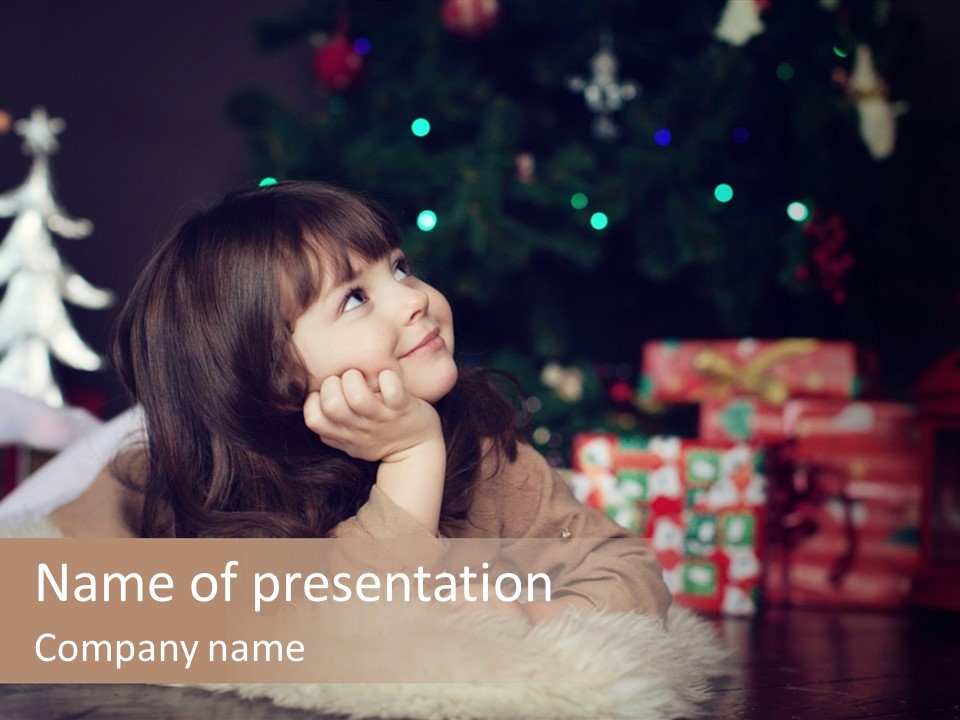 A Little Girl Sitting In Front Of A Christmas Tree PowerPoint Template