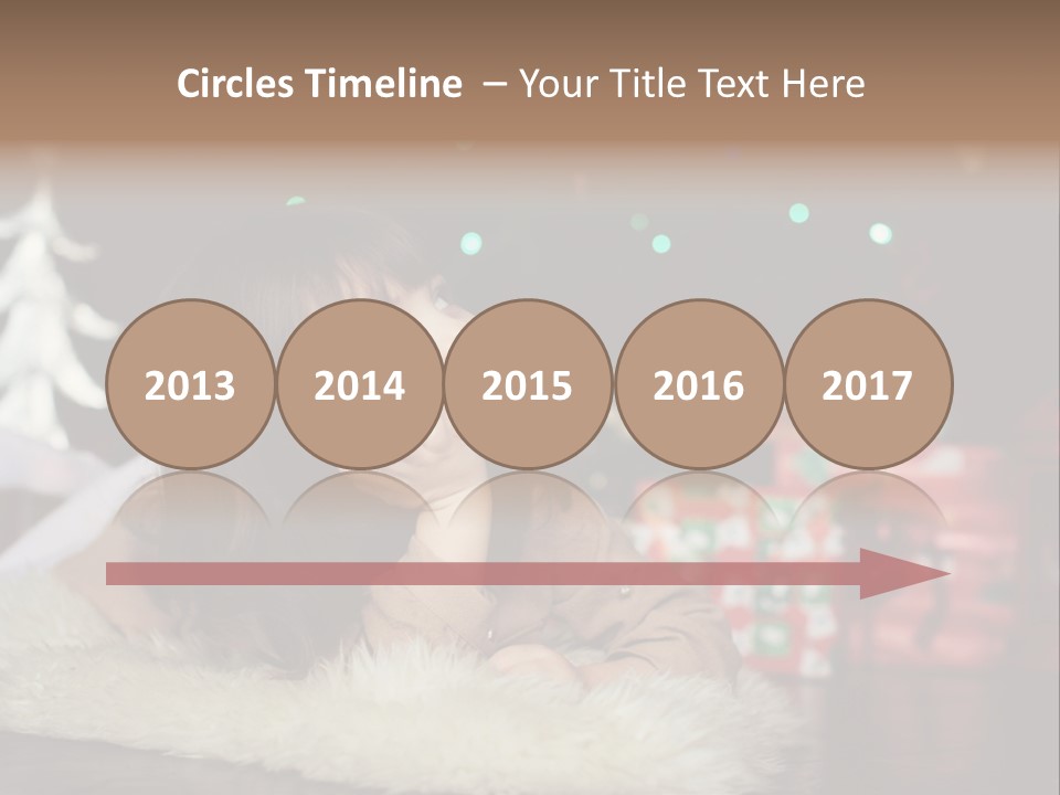 A Little Girl Sitting In Front Of A Christmas Tree PowerPoint Template