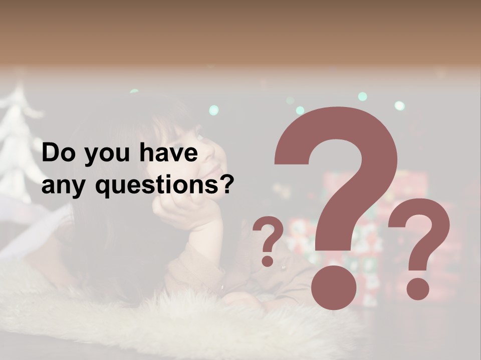 A Little Girl Sitting In Front Of A Christmas Tree PowerPoint Template