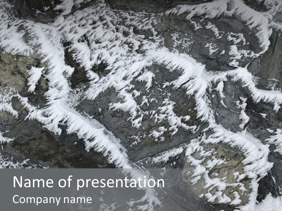 An Aerial View Of Snow Covered Rocks And Trees PowerPoint Template