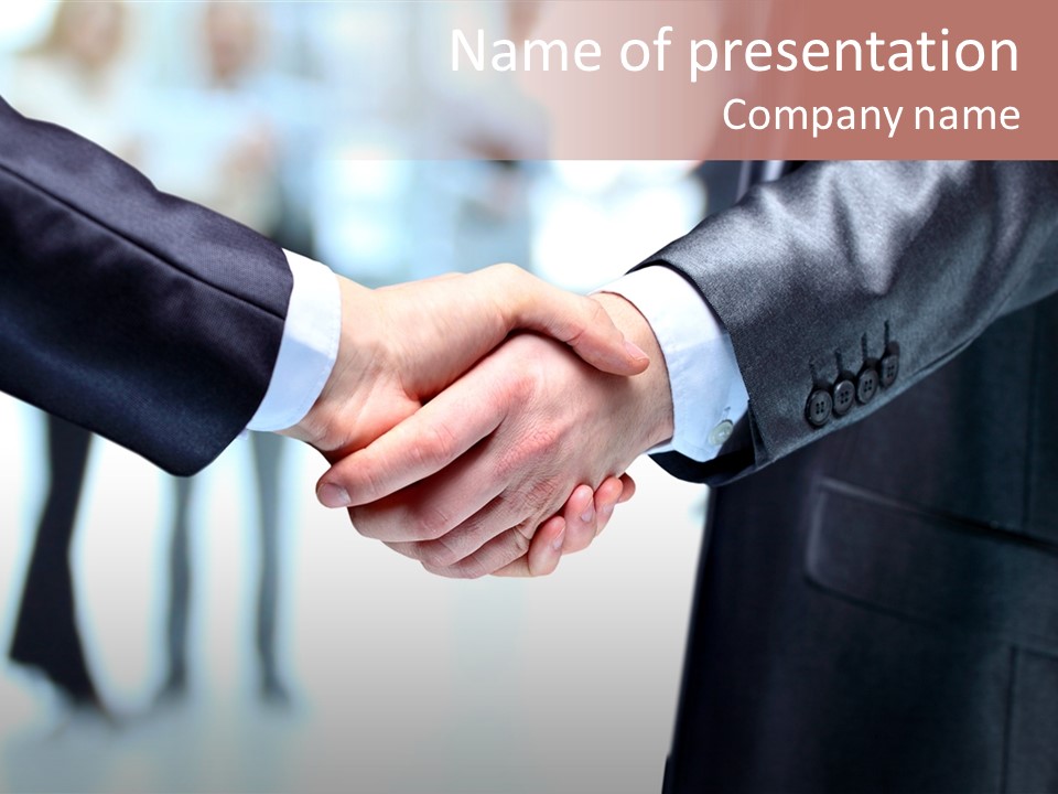 Two People Shaking Hands In Front Of A Group Of People PowerPoint Template