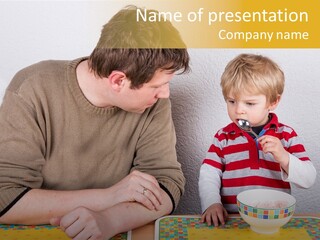 A Man And A Young Boy Sitting At A Table With A Bowl Of Food PowerPoint Template