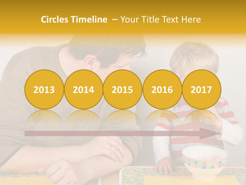 A Man And A Young Boy Sitting At A Table With A Bowl Of Food PowerPoint Template