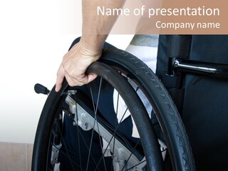 A Man In A Wheelchair Holding The Wheel Of A Wheel Chair PowerPoint Template
