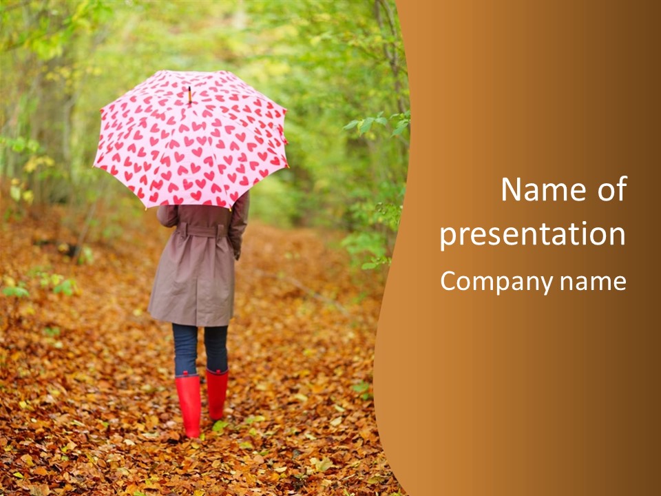 A Woman Walking Down A Leaf Covered Path Holding An Umbrella PowerPoint Template