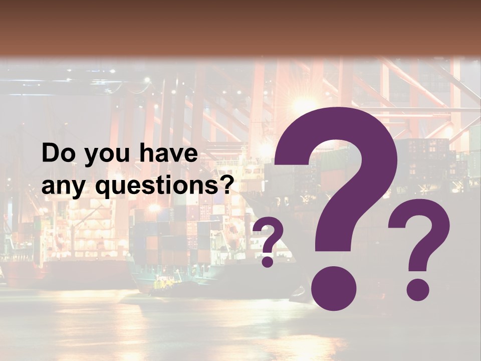 A Large Cargo Ship In A Harbor At Night PowerPoint Template