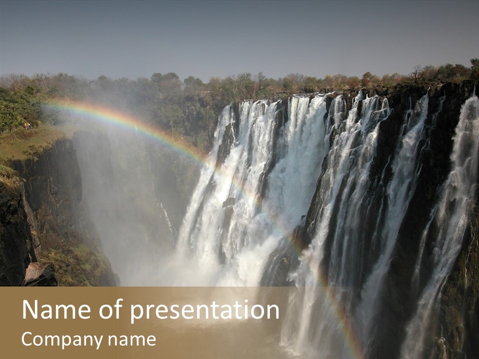 A Waterfall With A Rainbow In The Middle Of It PowerPoint Template
