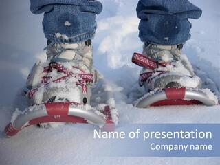 A Person Riding A Snowboard On Top Of Snow Covered Ground PowerPoint Template
