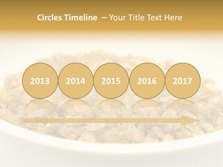 A White Bowl Filled With Cereal On Top Of A Table PowerPoint Template