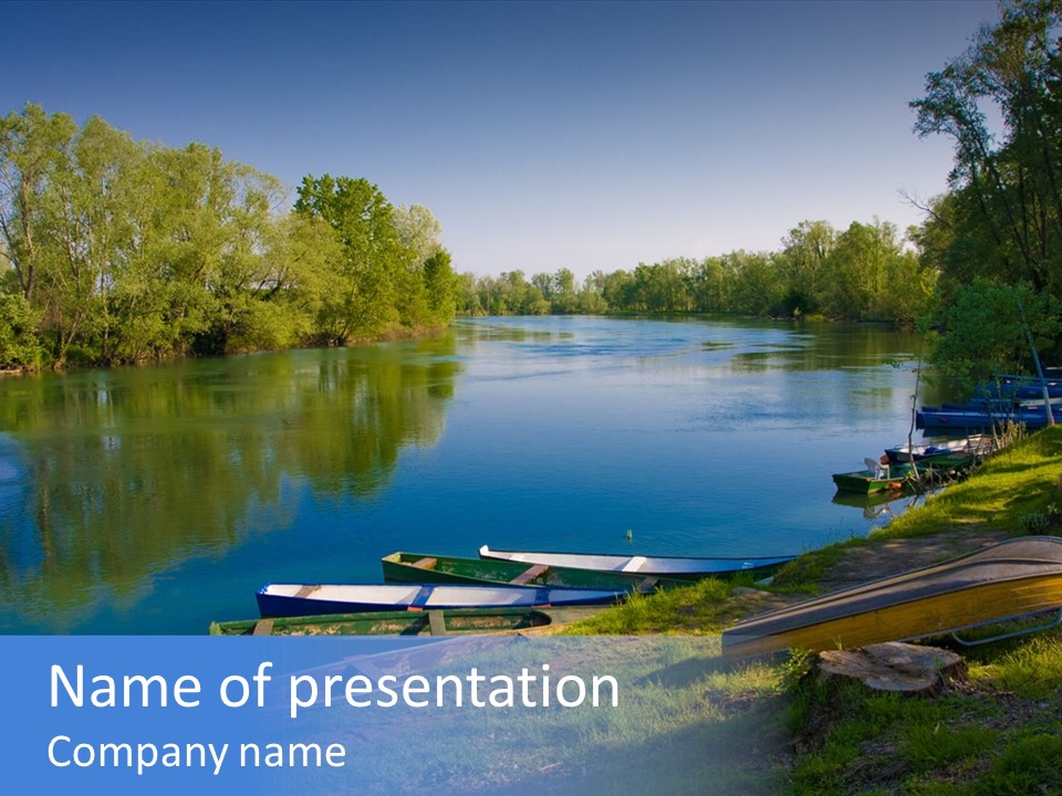 A Body Of Water Surrounded By Trees And Boats PowerPoint Template