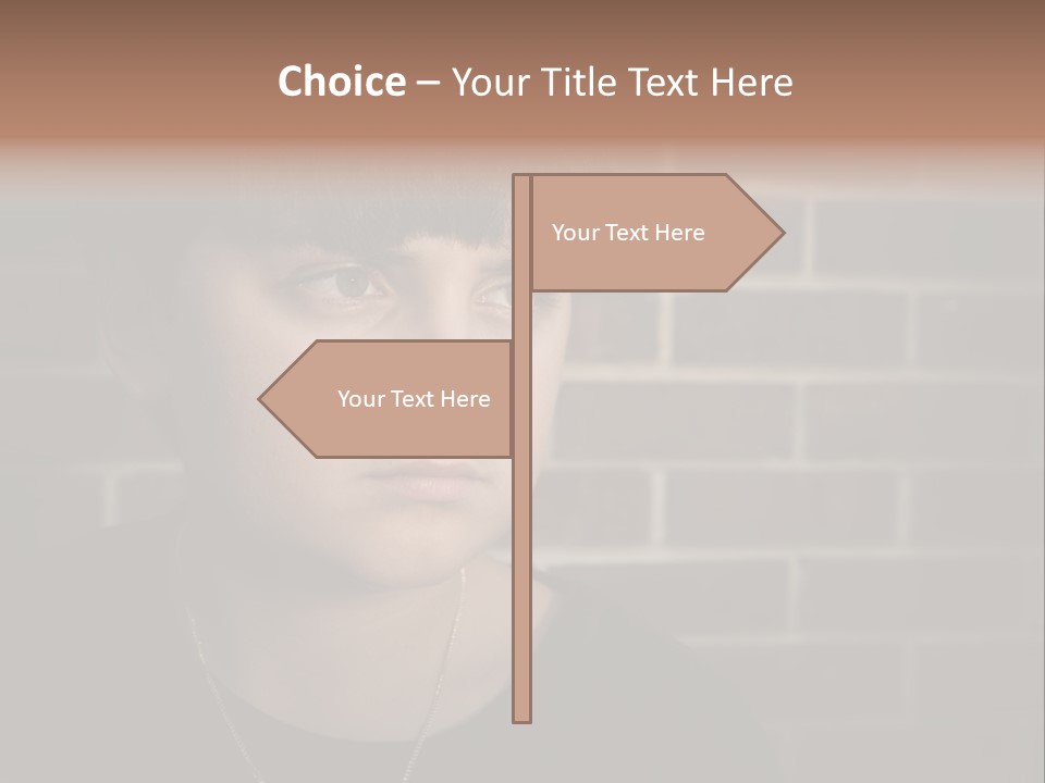 A Young Boy Is Looking At The Camera With A Brick Wall Behind Him PowerPoint Template