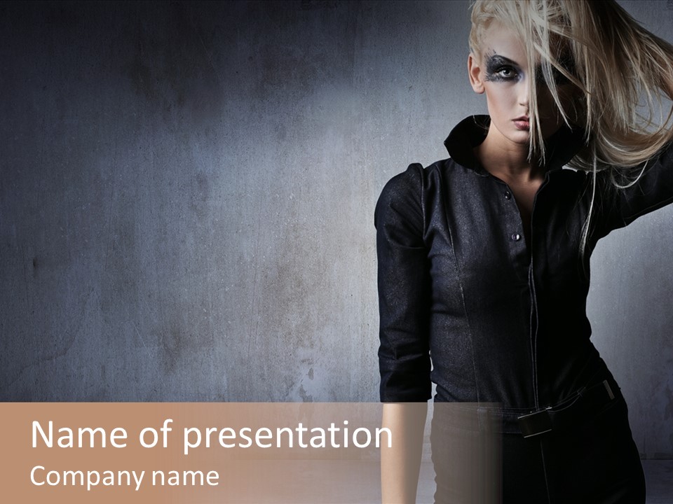 A Woman In Black Is Posing With Her Hair Blowing In The Wind PowerPoint Template
