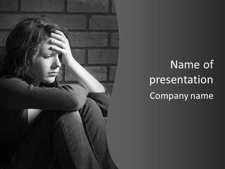 A Woman Sitting In Front Of A Brick Wall With Her Hands On Her Head PowerPoint Template