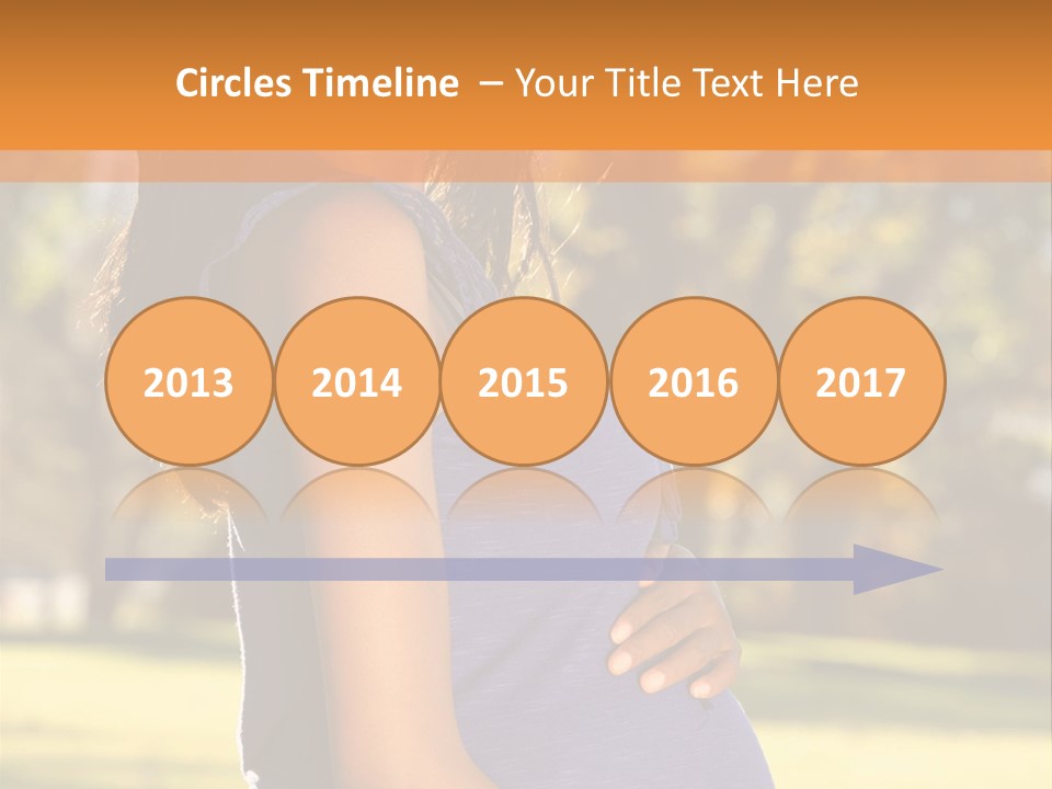 A Pregnant Woman In A Blue Dress Is Smiling PowerPoint Template