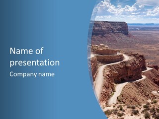 A Scenic View Of A Canyon With A Road Going Through It PowerPoint Template
