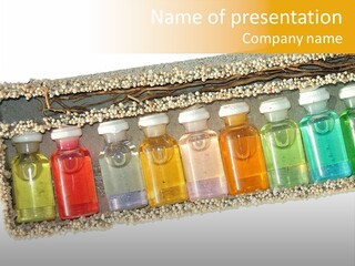 A Group Of Bottles Of Different Colors In A Box PowerPoint Template