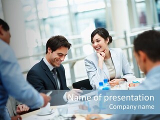 A Group Of Business People Sitting Around A Table PowerPoint Template