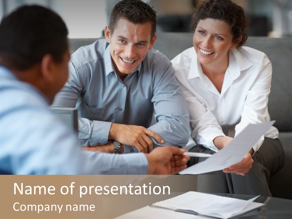 A Couple Of People Sitting At A Table With Papers PowerPoint Template